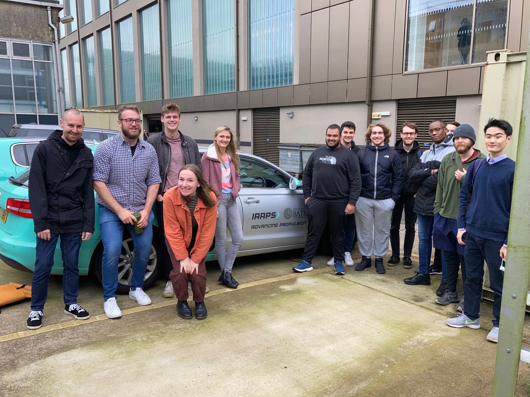 AAPS Cohort 3 students stood infront of an electric car